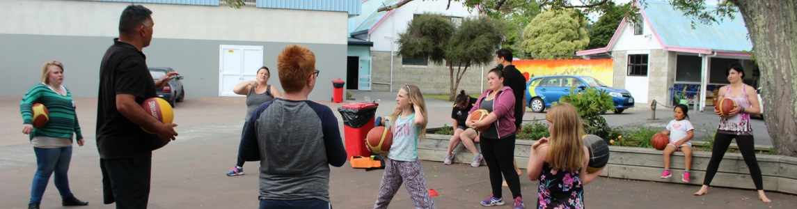 Ray Noble teaching children basketball as part of the active families programme